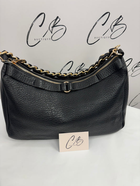 Black handbag with black and gold strap