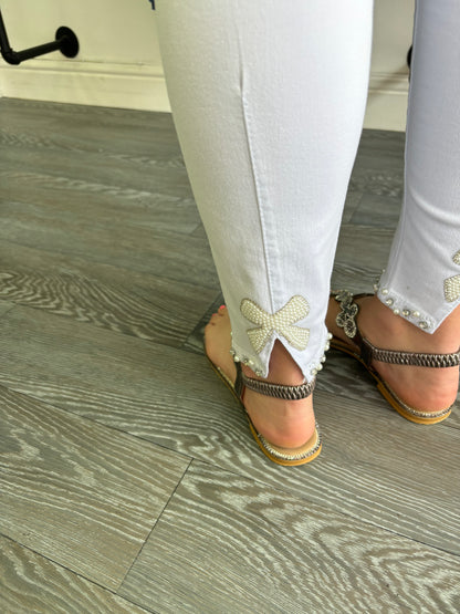 White denim jeans with sparkle bow